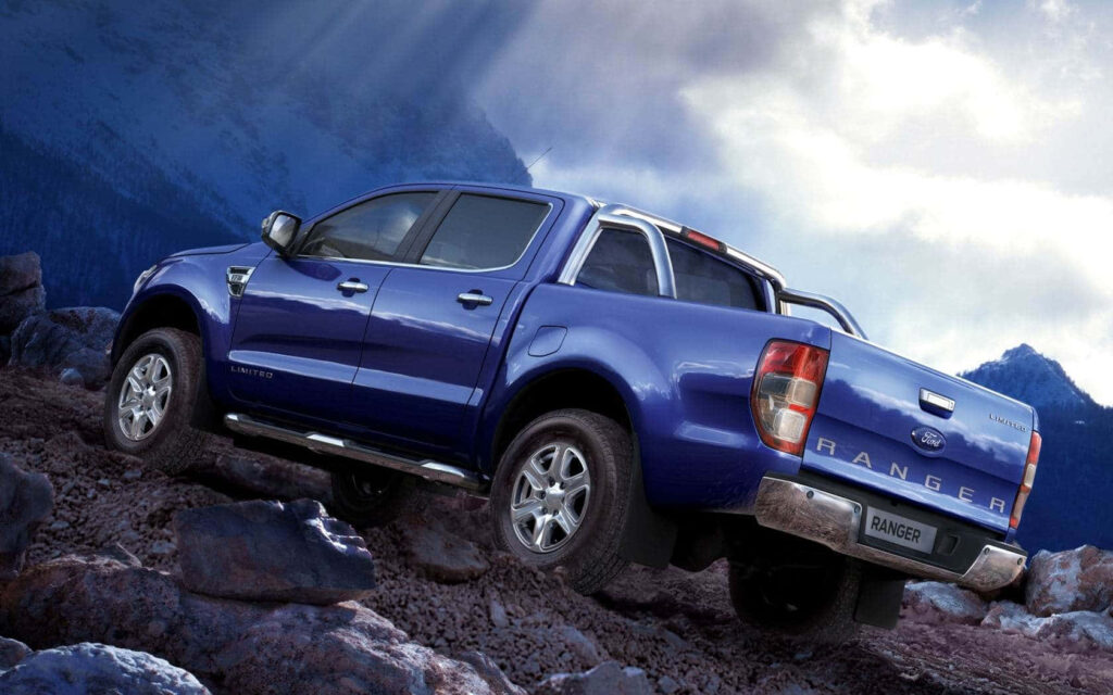 Ford Ranger driving rugged mountain terrain showcasing adventure and powerful off-road performance Wallpaper