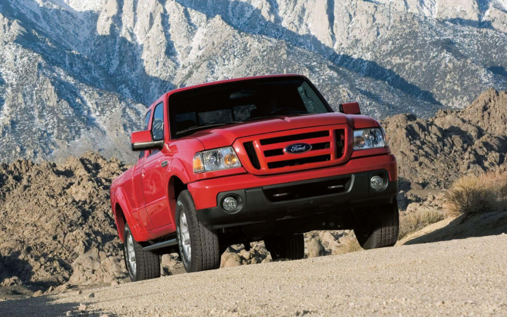 Ford Ranger on rocky terrain with snow-capped mountains showing rugged off-road capability Wallpaper