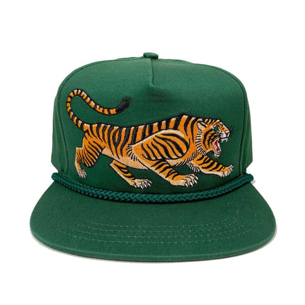 Forest green 5-panel cap with vibrant embroidered tiger on white background streetwear style Wallpaper