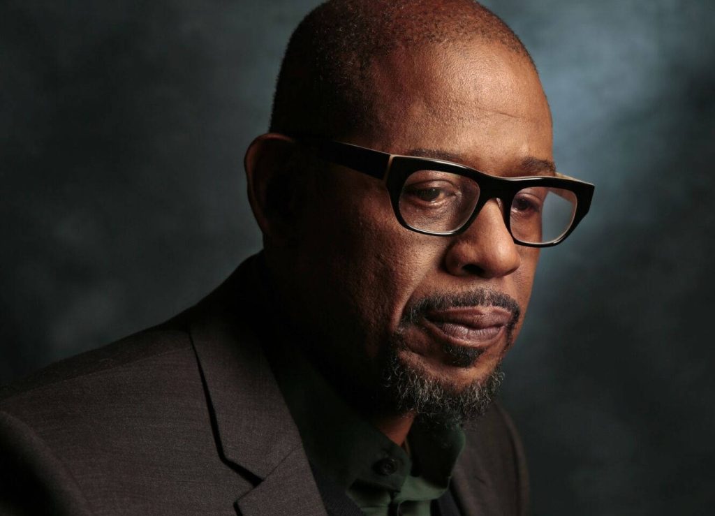 Forest Whitaker side profile portrait with thick glasses dramatic dark textured background wallpaper