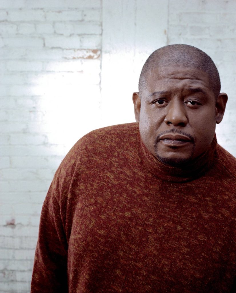 Forest Whitaker studio portrait in rust red turtleneck sweater white brick background wallpaper