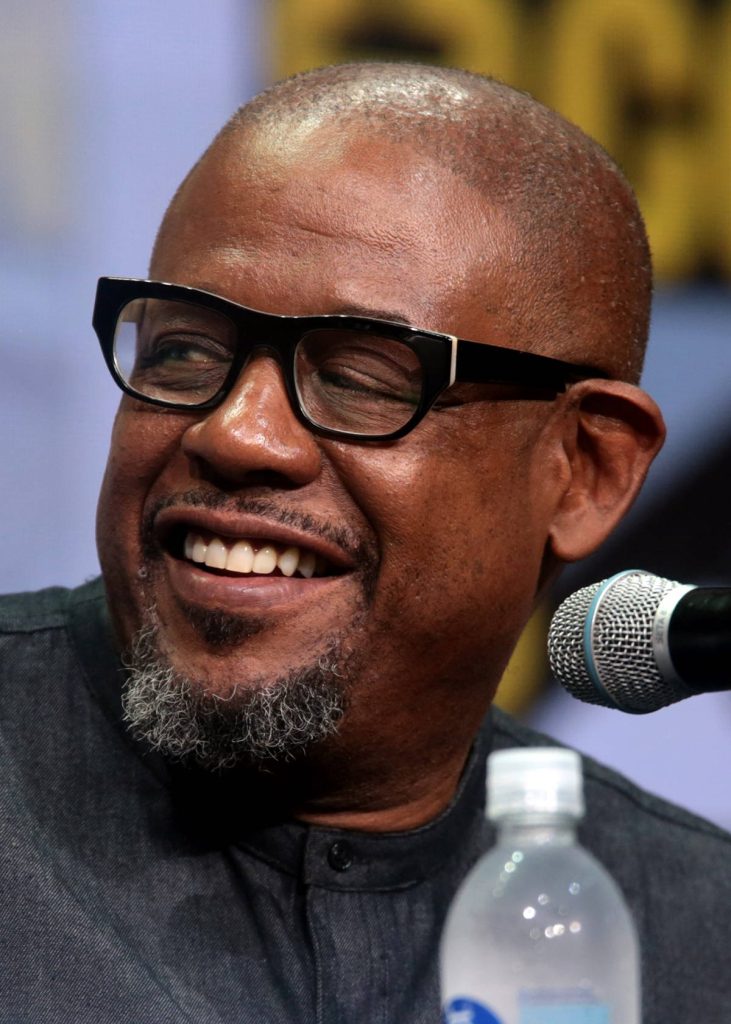 Forest Whitaker close-up smiling at San Diego Comic-Con 2017 panel with microphone and glasses Wallpaper