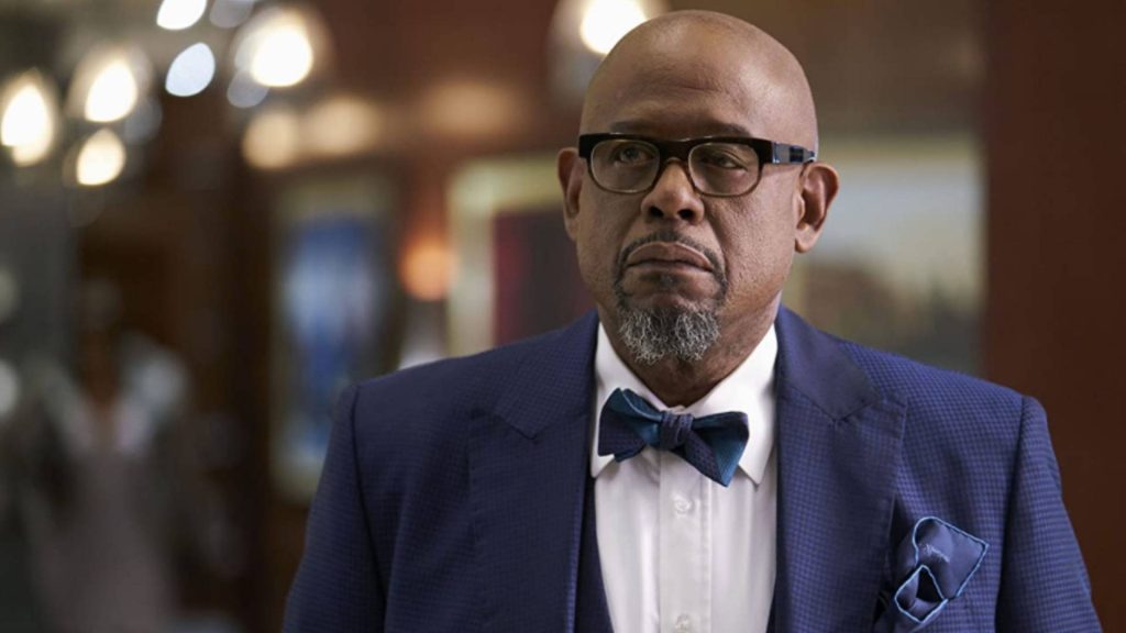 Forest Whitaker serious portrait in blue patterned blazer white shirt bow tie warm bokeh light Wallpaper
