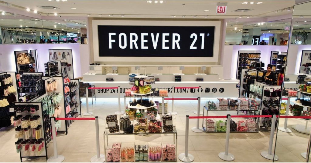 Bright interior of Forever 21 store with black white logo aisles of fashion accessories and displays Wallpaper