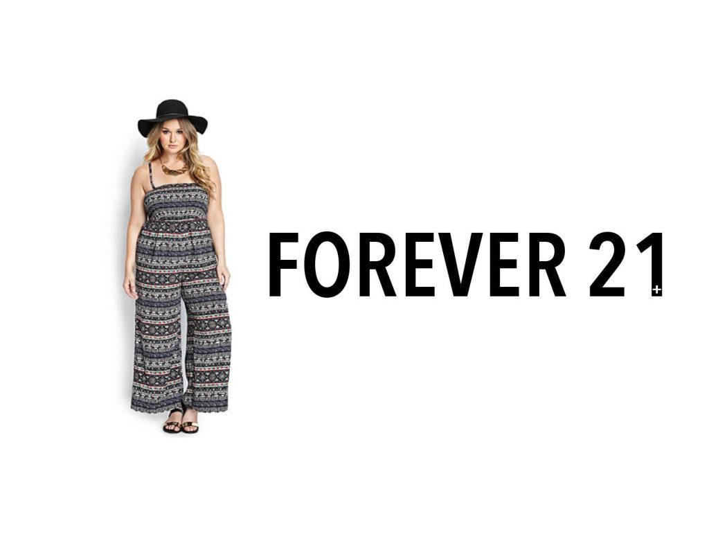 Model in trendy patterned jumpsuit and black hat with Forever 21 logo on white background wallpaper