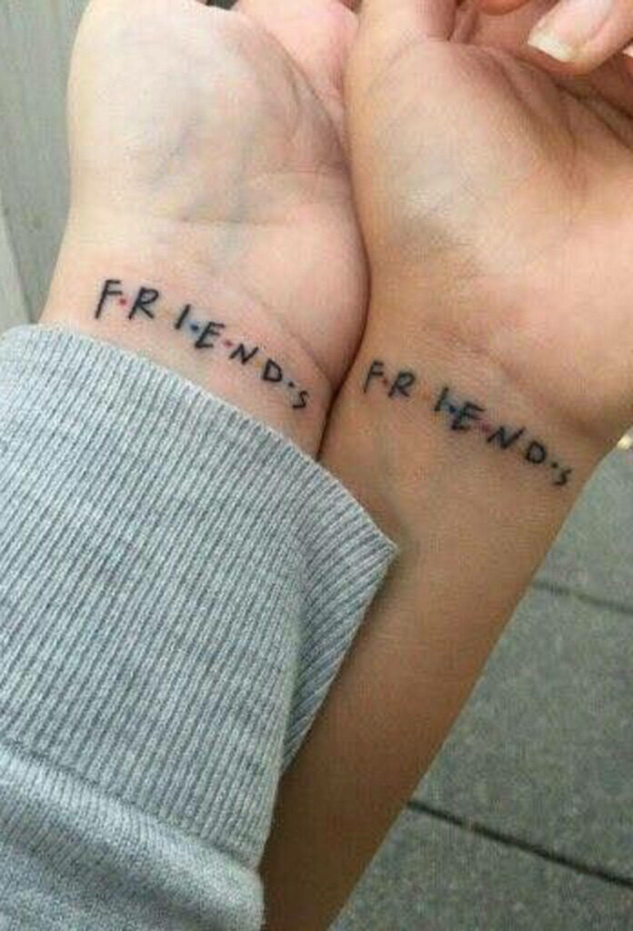 Bonded by a 90s TV Show: Captivating Image of Best Friends with Identical Friends Logo Tattoos Wallpaper