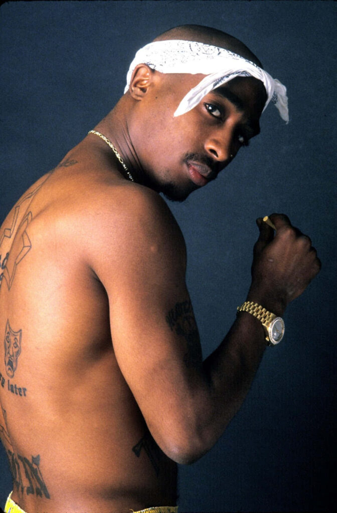 Legacy Unleashed: Tupac Shakur's Iconic Image Captures Defiance and Inspires Generations Wallpaper