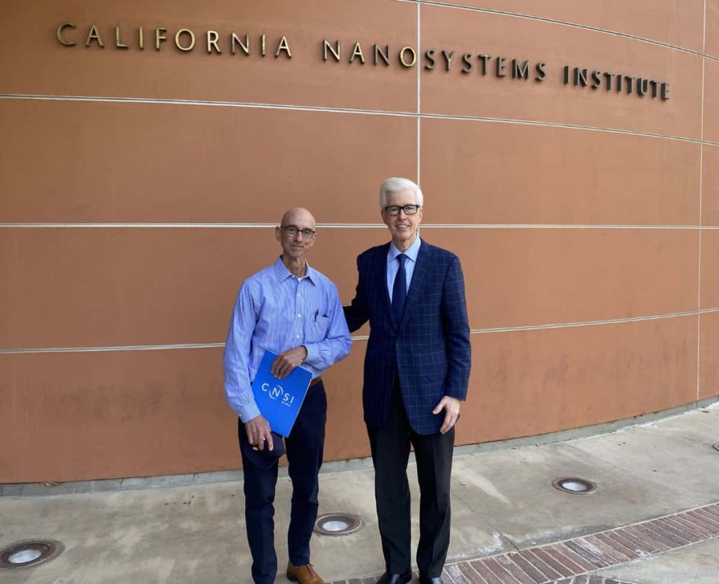 Former California Governor Gray Davis visits California Nanosystems Institute posing with staff outdoors Wallpaper