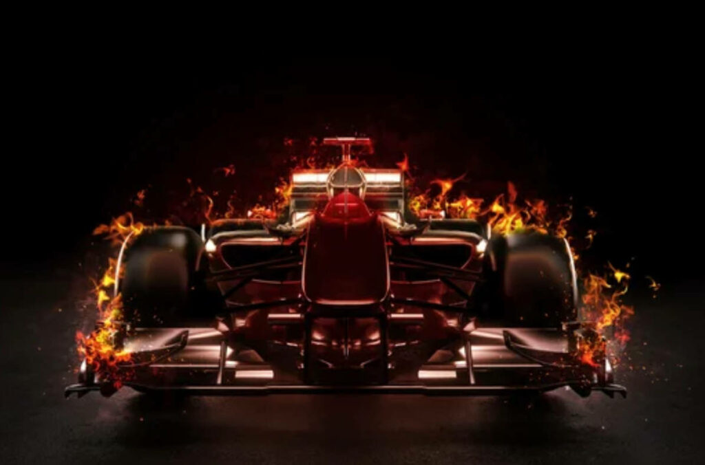 High-resolution 4K wallpaper of a fiery Formula 1 car racing with intense flames on dark background
