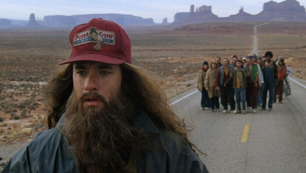 “Forrest Gump Running Wallpaper: Iconic Desert Scene with Bubba Gump Hat”