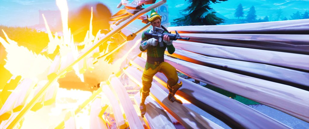 Fortnite Codename ELF character aiming assault rifle on ramp with vibrant explosion background Wallpaper