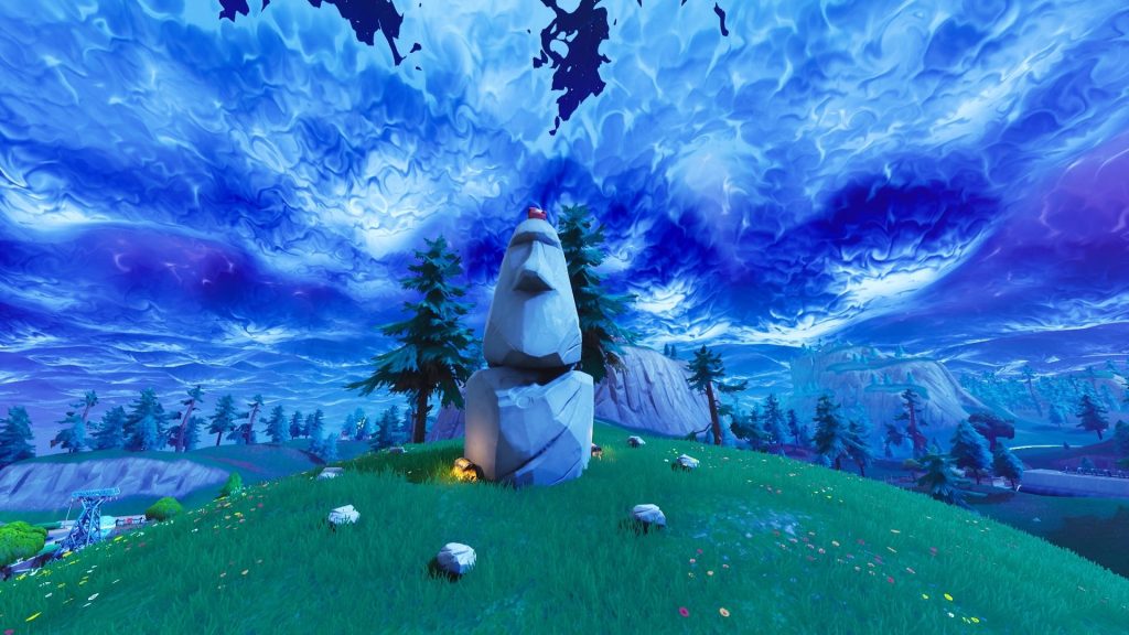 Fortnite Battle Royale Moai stone head on grassy hill with swirling blue purple storm sky background Wallpaper