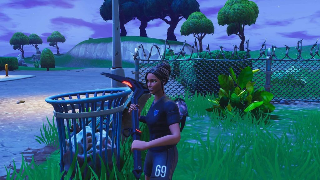Fortnite Poised Playmaker soccer skin in dark kit number 69 beside blue trash can at twilight Wallpaper