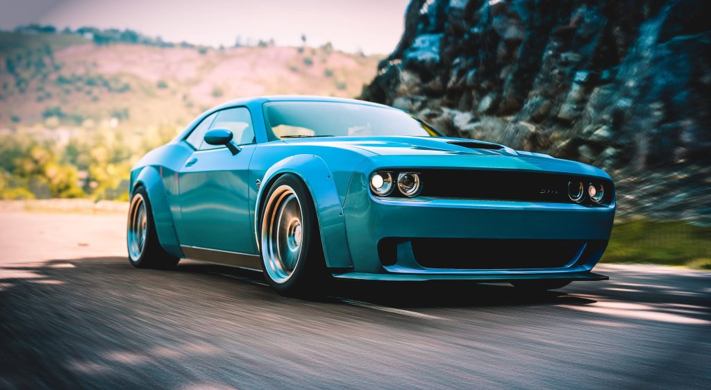 Vibrant widebody Dodge Challenger racing on scenic Forza Horizon 4 road with mountain backdrop Wallpaper
