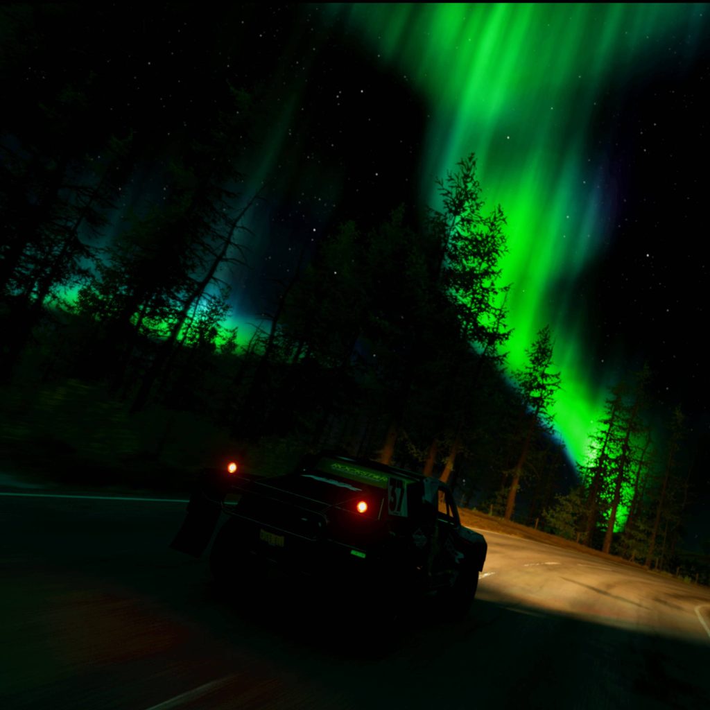 Black racing truck speeding on forest road under vibrant green Aurora Borealis in Forza Horizon 4 Wallpaper