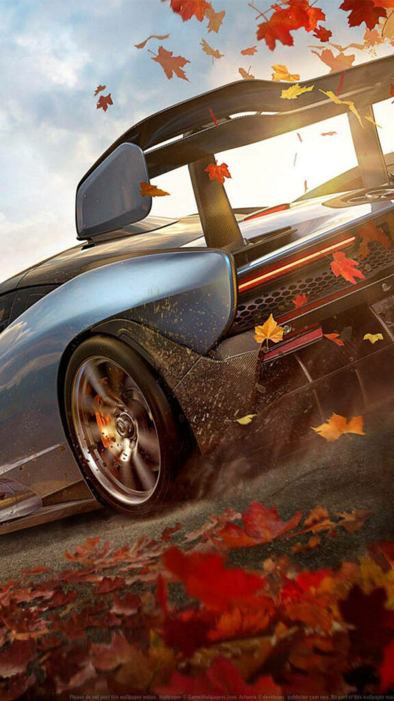 Forza high-performance sports car racing through vibrant autumn leaves scenic gaming wallpaper