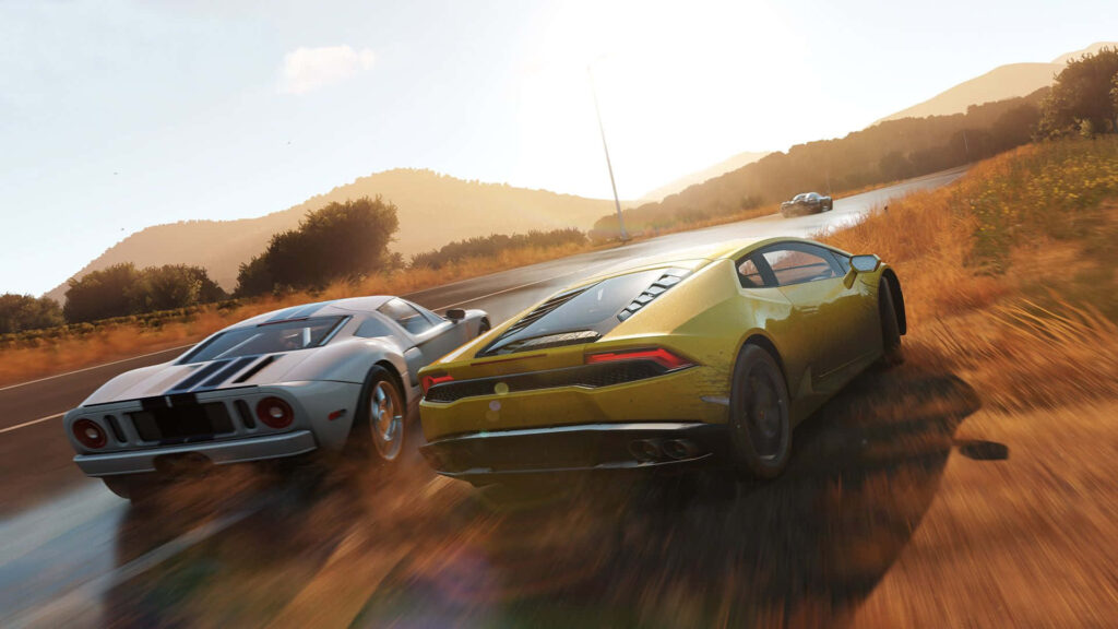 Two high-performance sports cars racing on scenic countryside road at sunset Forza wallpaper
