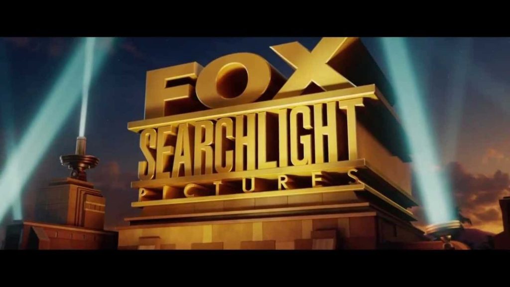 Fox Searchlight Pictures logo with gold metallic structure illuminated by spotlights at twilight Wallpaper