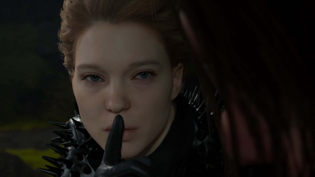 Fragile from Death Stranding in black spiked suit making hush gesture close-up CGI wallpaper