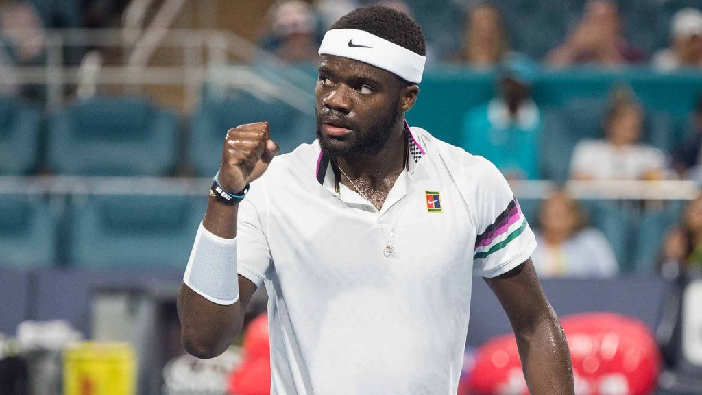 Frances Tiafoe celebrates victory on tennis court wearing Nike gear and No Quit wristband Wallpaper