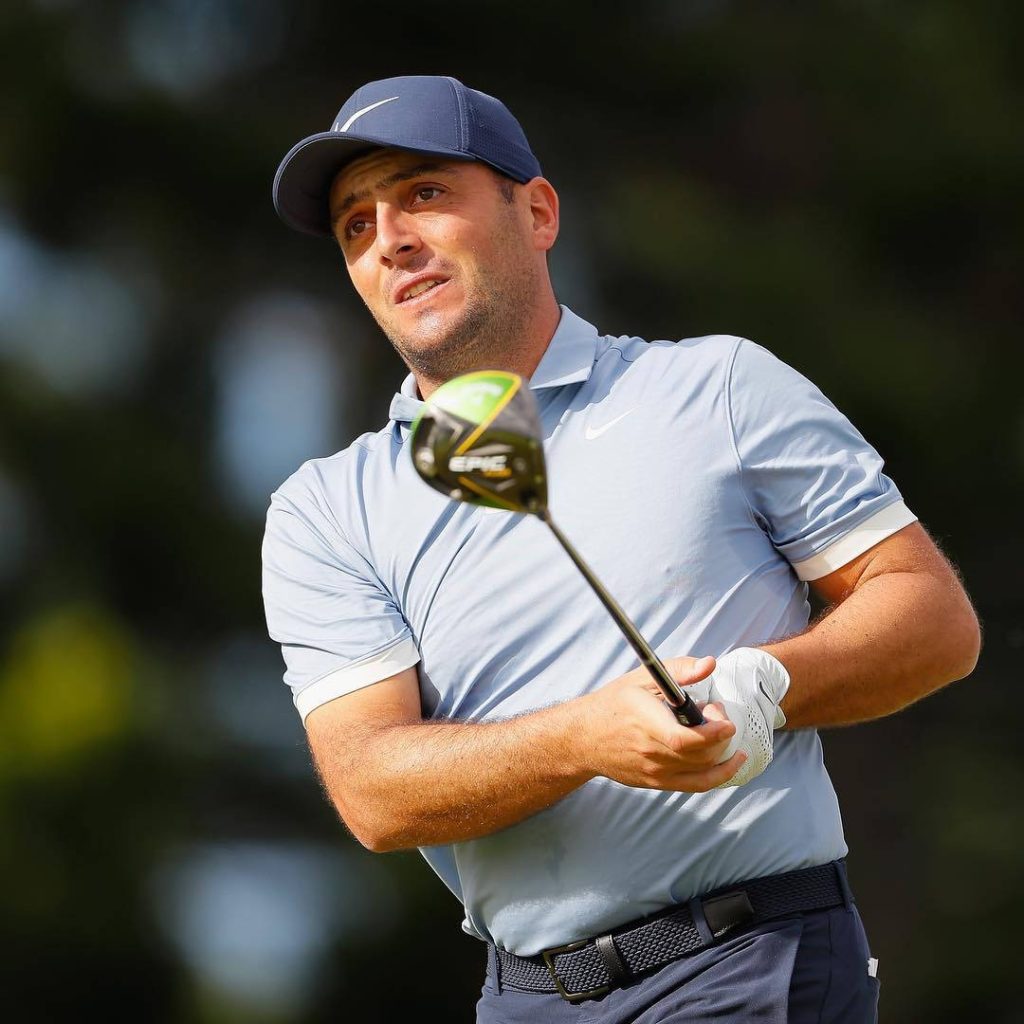 Francesco Molinari mid-swing in light blue Nike golf attire with Callaway Epic driver outdoors Wallpaper