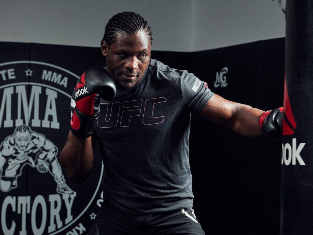 Francis Ngannou training on heavy bag MMA Factory UFC Reebok shirt fight sports wallpaper