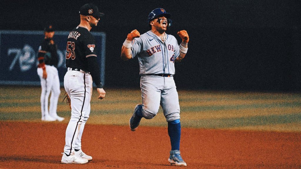 Francisco Alvarez Mets catcher fist-pumping in grey uniform on baseball diamond wallpaper