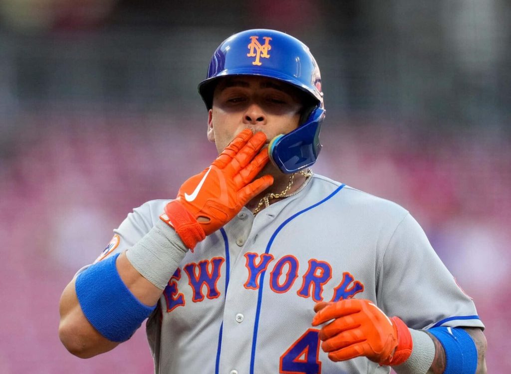 Francisco Alvarez Mets catcher in grey uniform with blue helmet and orange gloves blowing kiss Wallpaper