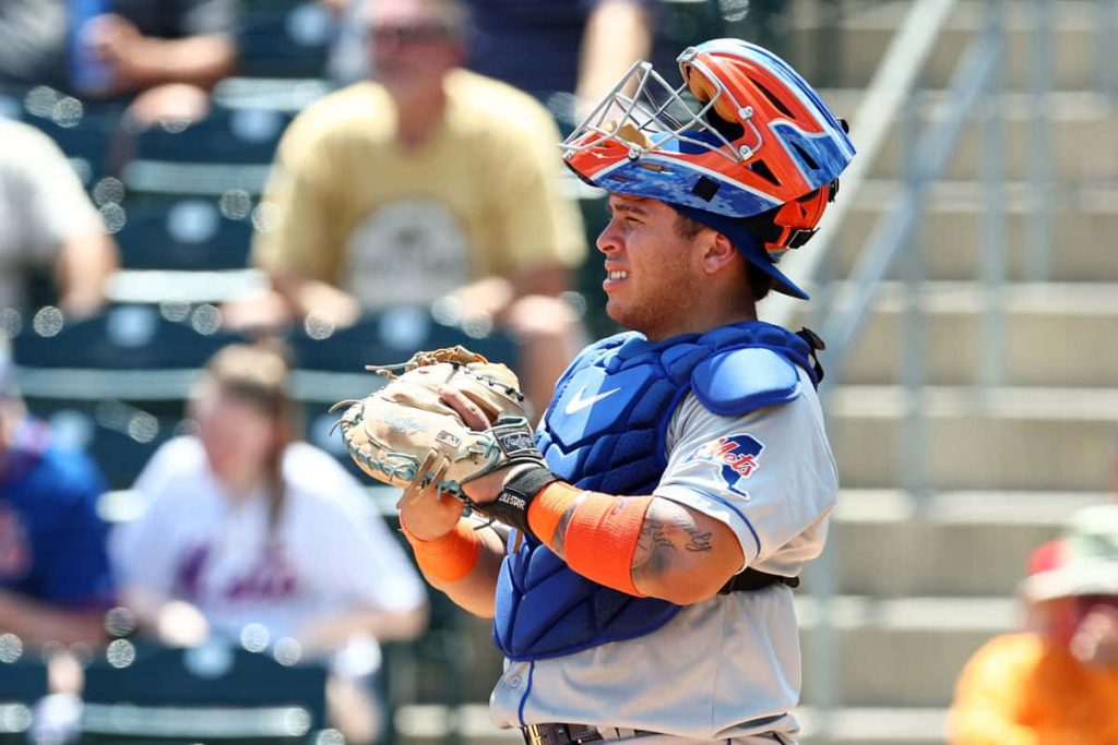Francisco Alvarez New York Mets catcher in blue orange gear focused in stadium background Wallpaper