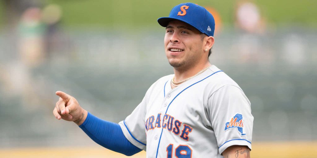 Francisco Alvarez in Syracuse Mets uniform smiling and pointing on field vibrant sports wallpaper