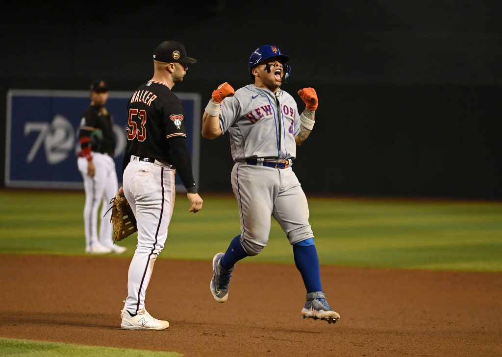 Francisco Alvarez celebrating in New York Mets uniform with Diamondbacks Christian Walker behind Wallpaper