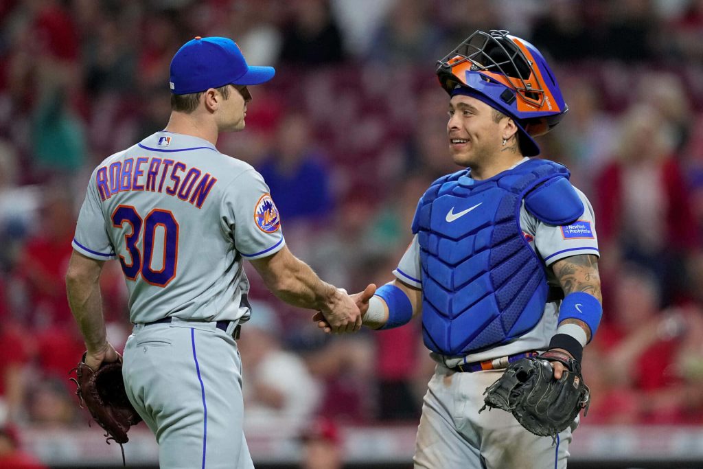 New York Mets catcher Francisco Álvarez shaking hands with pitcher David Robertson in gray uniforms Wallpaper