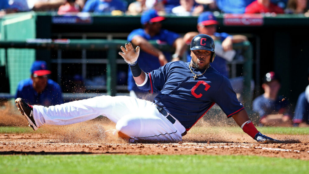 Francisco Lindor slides into home plate for Cleveland Indians sunny baseball game vibrant action Wallpaper