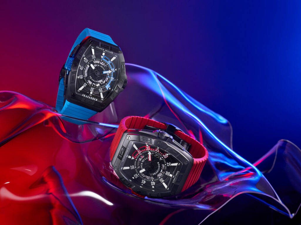 Two Franck Muller Skafander diver watches with blue and red straps on neon-lit abstract background Wallpaper
