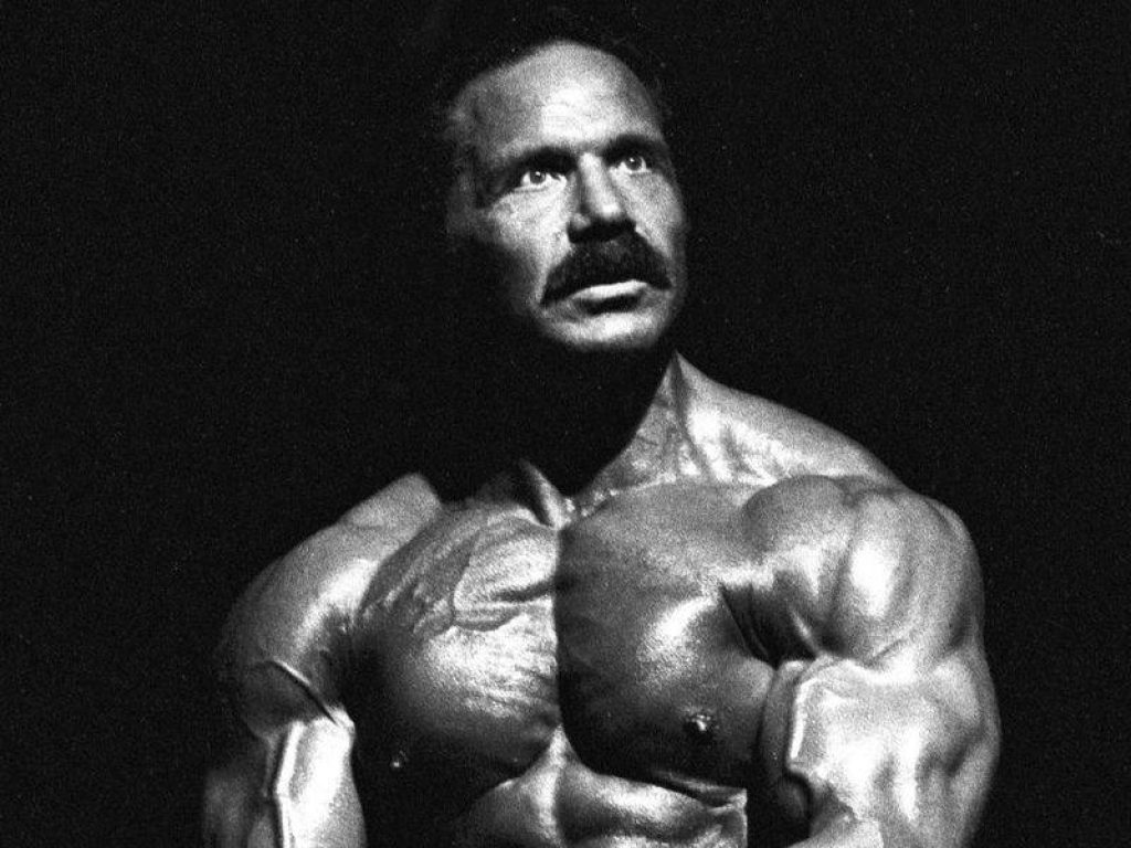 Franco Columbu black and white bodybuilding portrait intense gaze dramatic muscle definition wallpaper