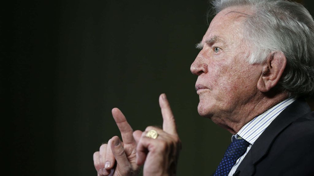 Frank McCourt former Los Angeles Dodgers owner in dark suit gesturing against neutral background Wallpaper