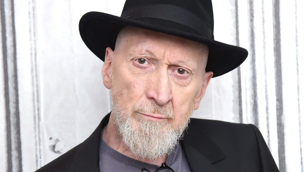 Frank Miller comic book writer artist intense gaze black fedora dark jacket studio portrait Wallpaper