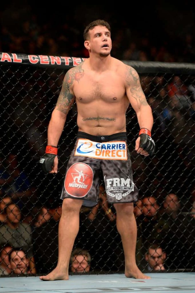 Frank Mir UFC heavyweight fighting stance in octagon with bright arena lighting background Wallpaper