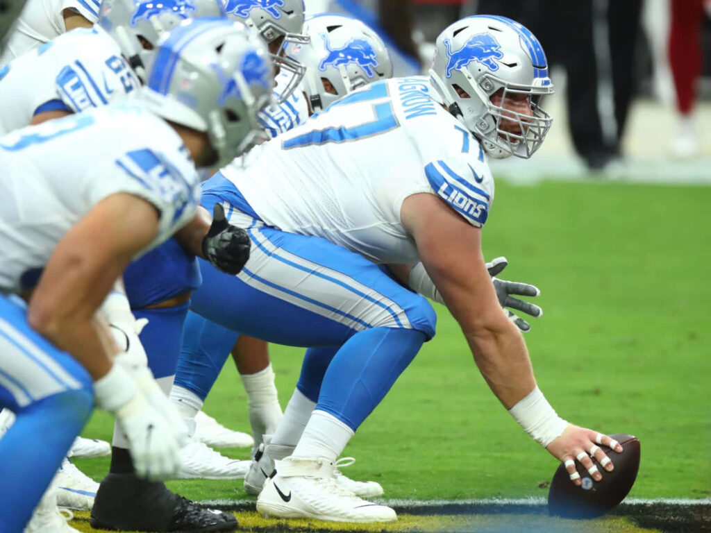Detroit Lions offensive line led by Frank Ragnow in blue silver uniforms at line of scrimmage Wallpaper