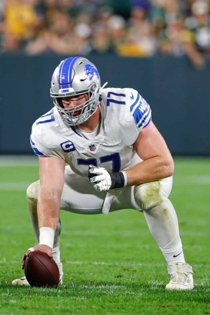 Detroit Lions center Frank Ragnow in white jersey focused ready in action NFL sports wallpaper