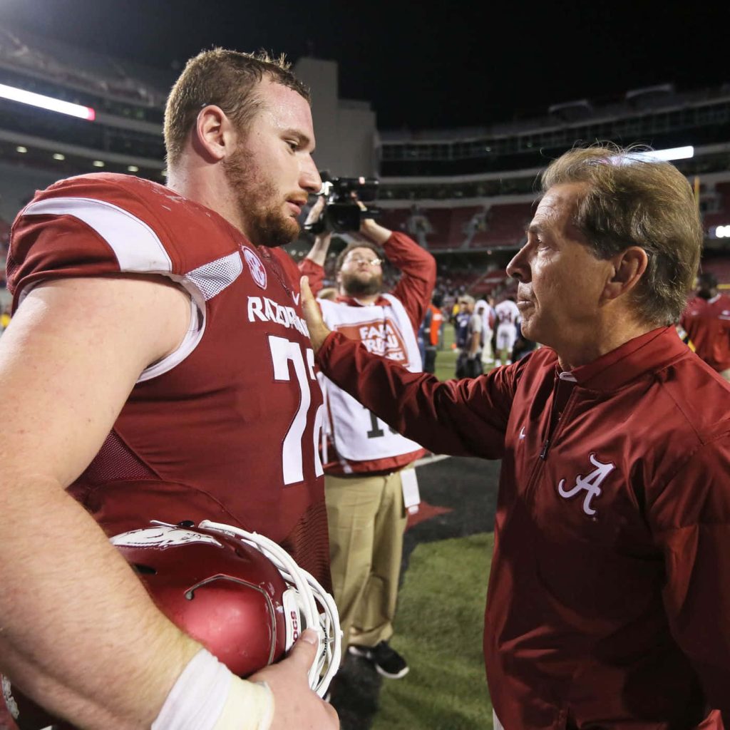 Arkansas Razorbacks lineman Frank Ragnow talks with Alabama coach Nick Saban post game stadium lights Wallpaper