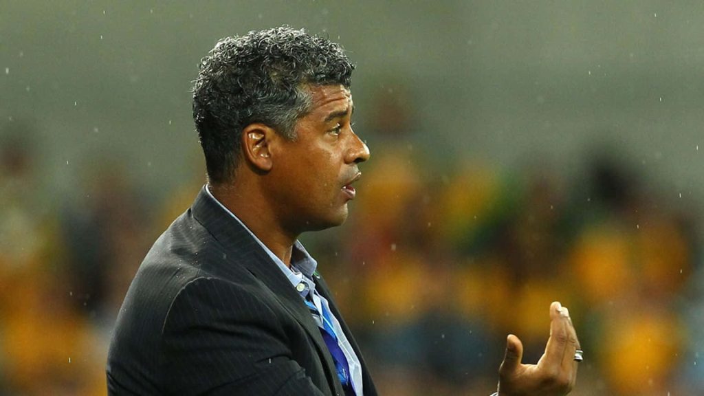Frank Rijkaard in sharp pinstripe suit gesturing at stadium high definition soccer wallpaper