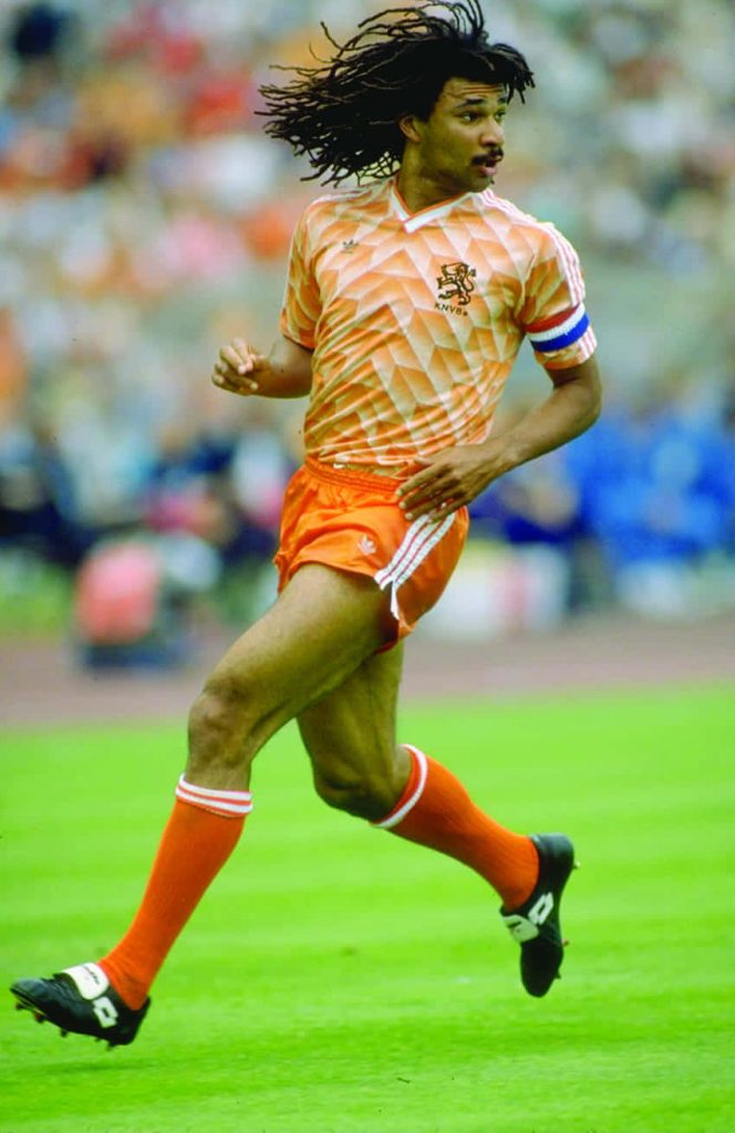 Frank Rijkaard in Netherlands orange kit running on pitch iconic football wallpaper background