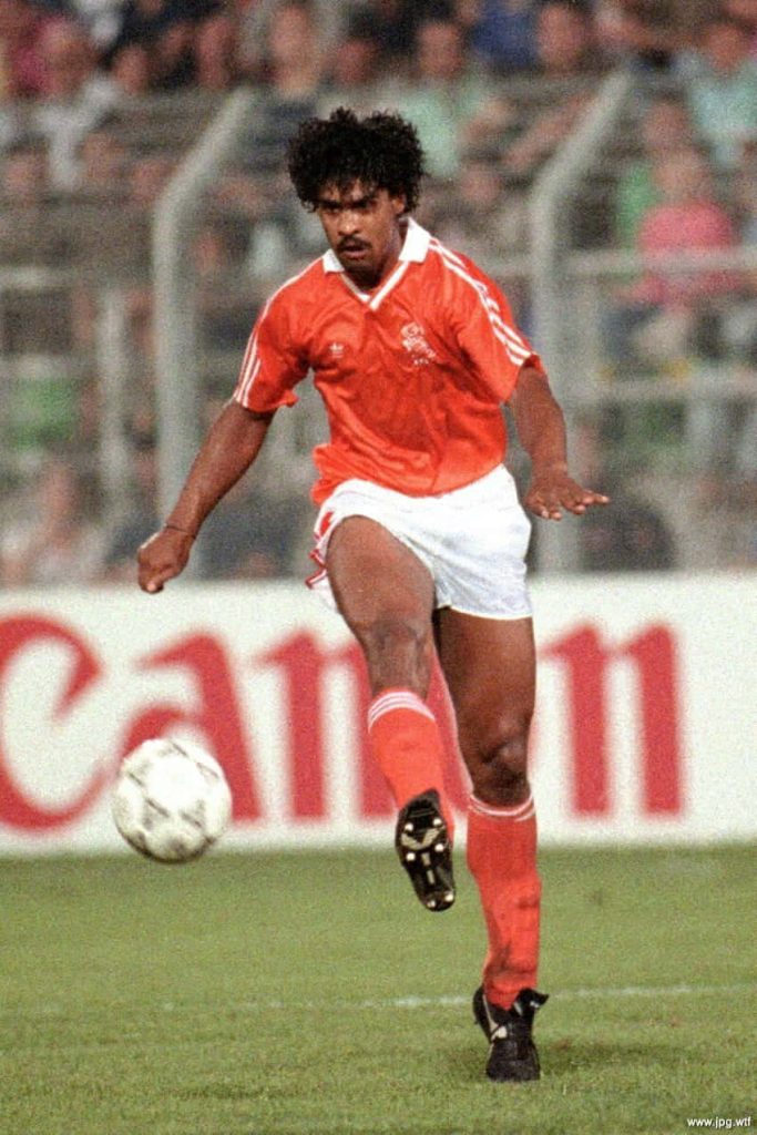 Frank Rijkaard dribbling in classic orange Netherlands kit at Canon stadium vintage football wallpaper