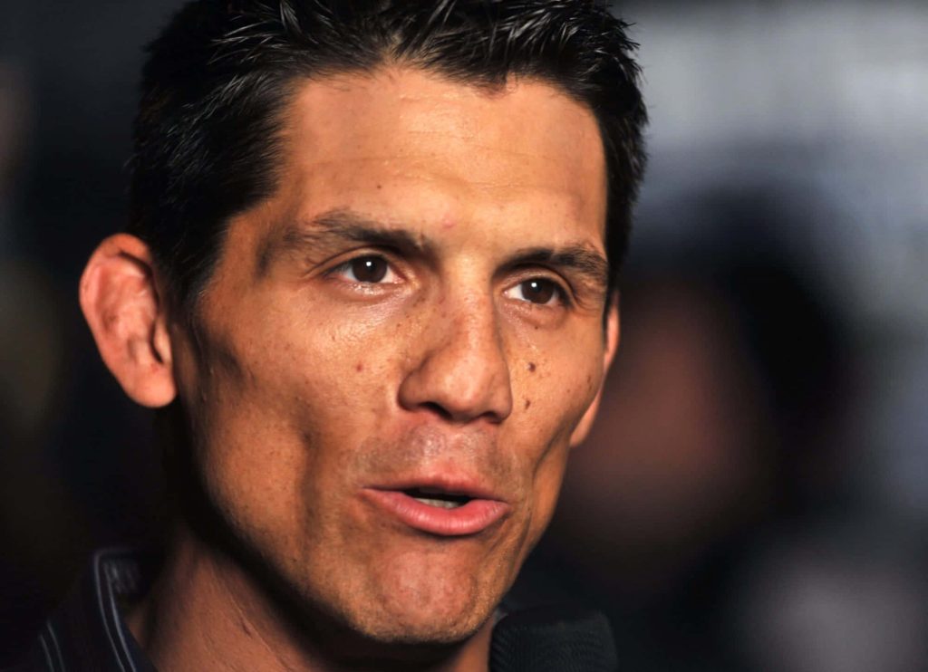 Close-up portrait of MMA legend Frank Shamrock with intense expression and dark background wallpaper