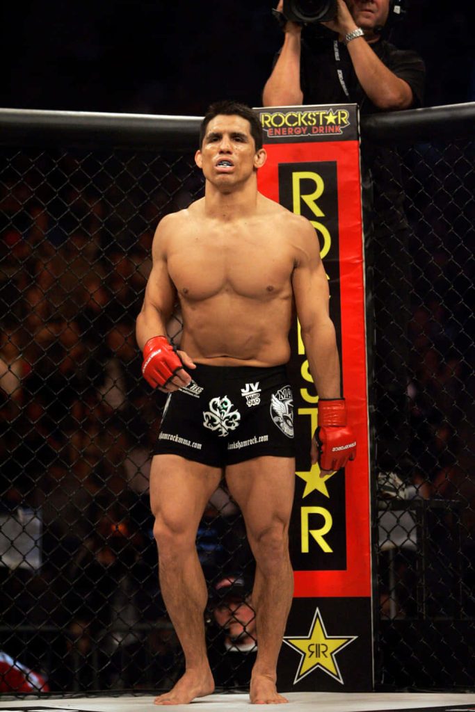 MMA legend Frank Shamrock focused inside Strikeforce cage with Rockstar Energy banner background Wallpaper