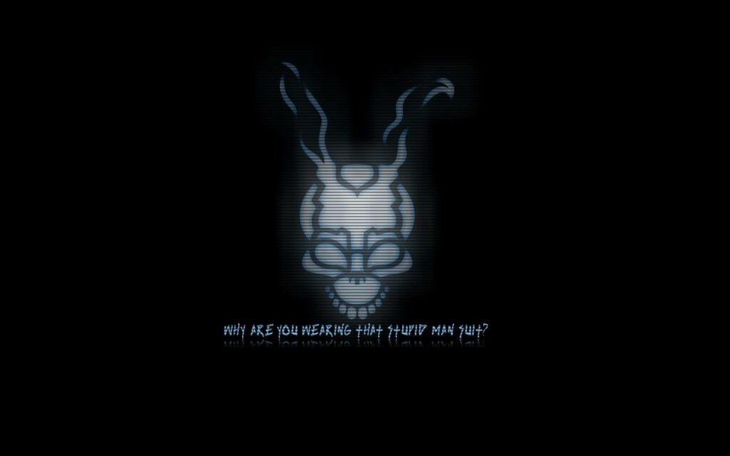 Frank the Rabbit from Donnie Darko with stylized skull head and glitchy text on dark background Wallpaper