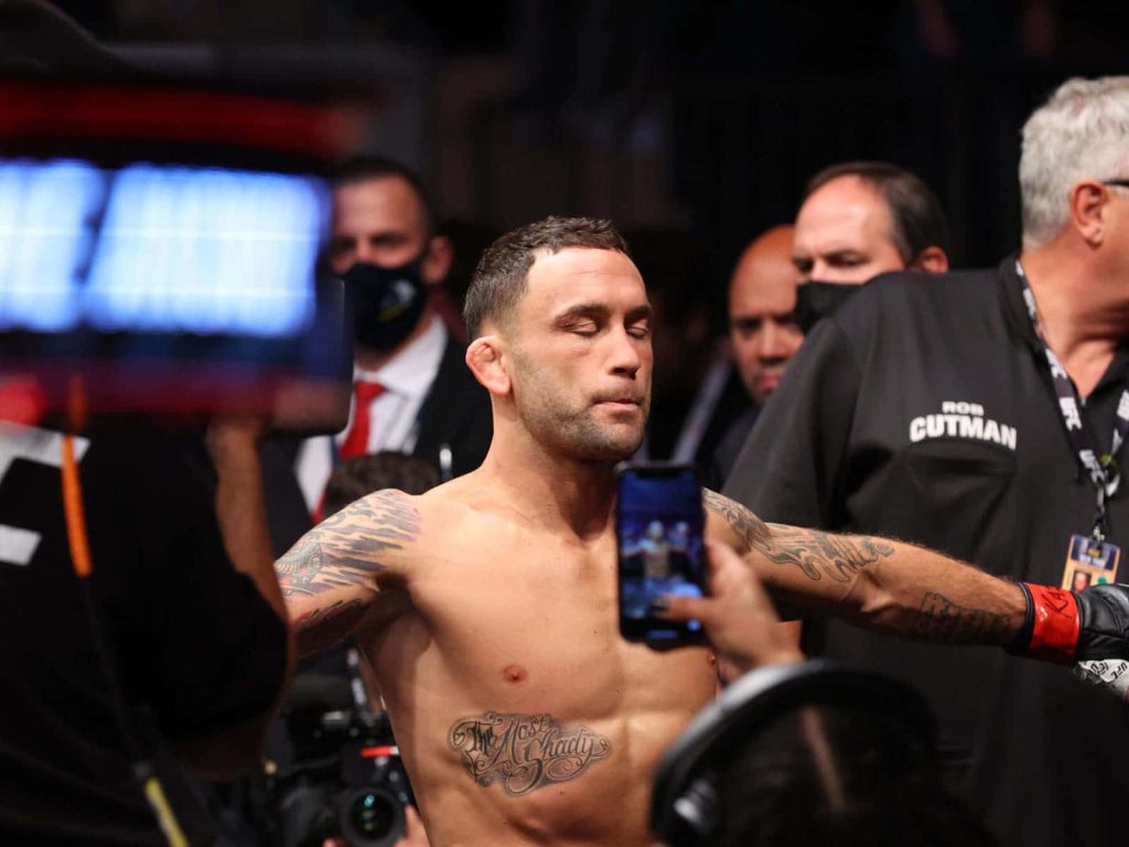 Frankie Edgar MMA fighter with arms outstretched in intense UFC 268 arena showdown wallpaper