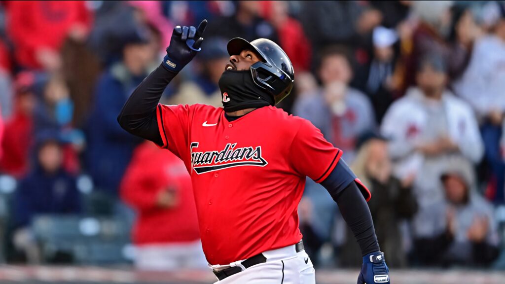 Franmil Reyes Cleveland Guardians celebrating in red jersey and helmet with blurred crowd background Wallpaper