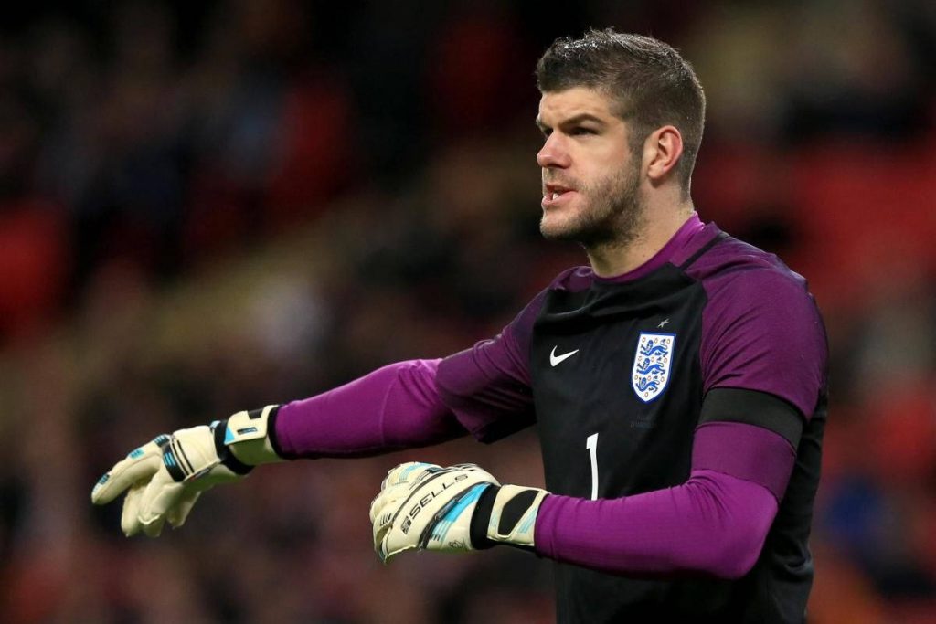 England goalkeeper Fraser Forster in purple kit pointing right wearing Sells gloves stadium background Wallpaper